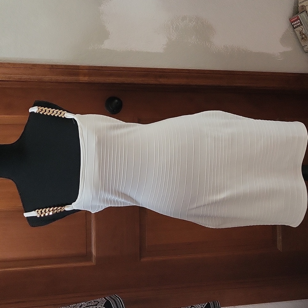 White ribbed dress with gold strap accents.